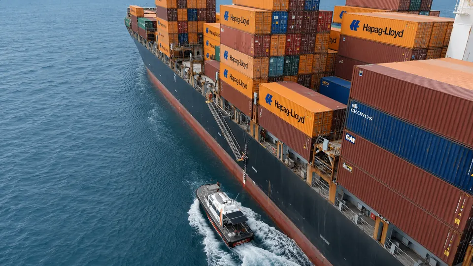 Pilot launch alongside a container ship
