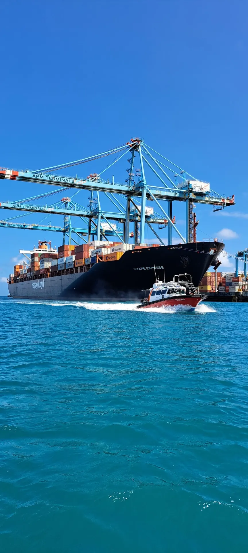 Fortim launch alongside a container ship during a port operation